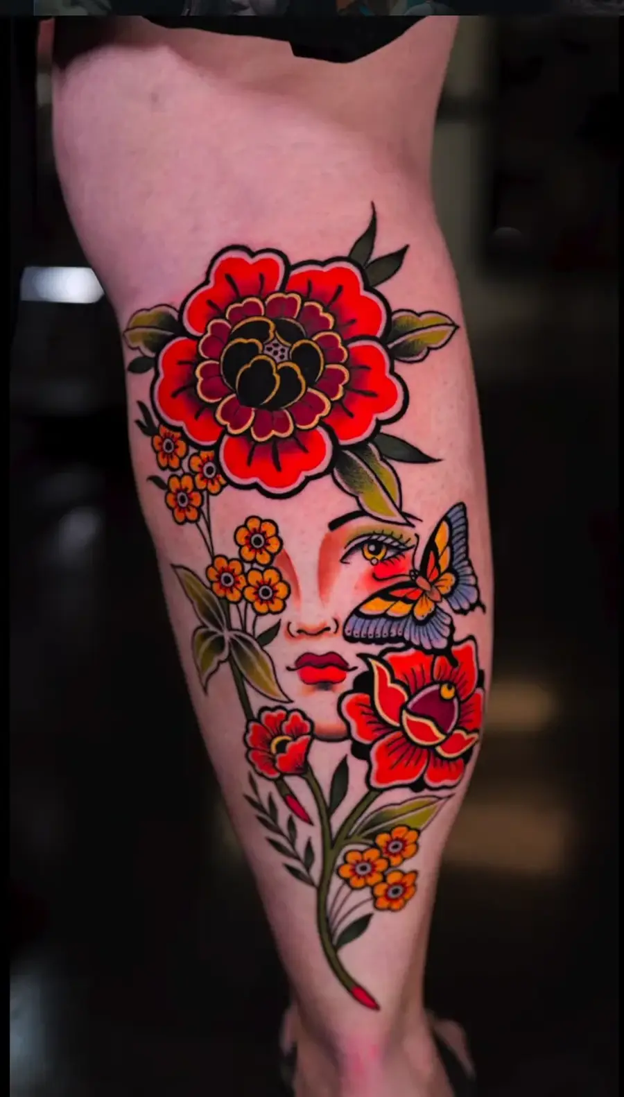 Traditional Flowers — color tattoo on calf by Amed Cid, Miami